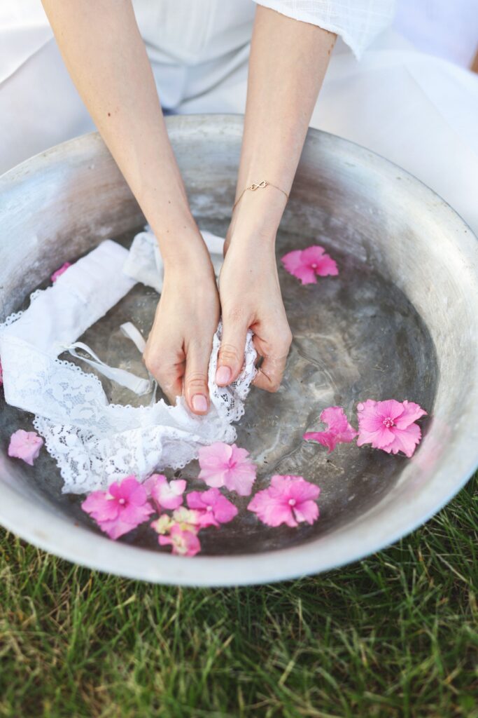 Hand washing delicate white lace bra in lukewarm water